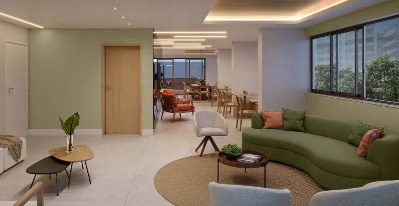 Salão de festas lounge do Dom Park Residencial com sofá curvo verde e poltronas